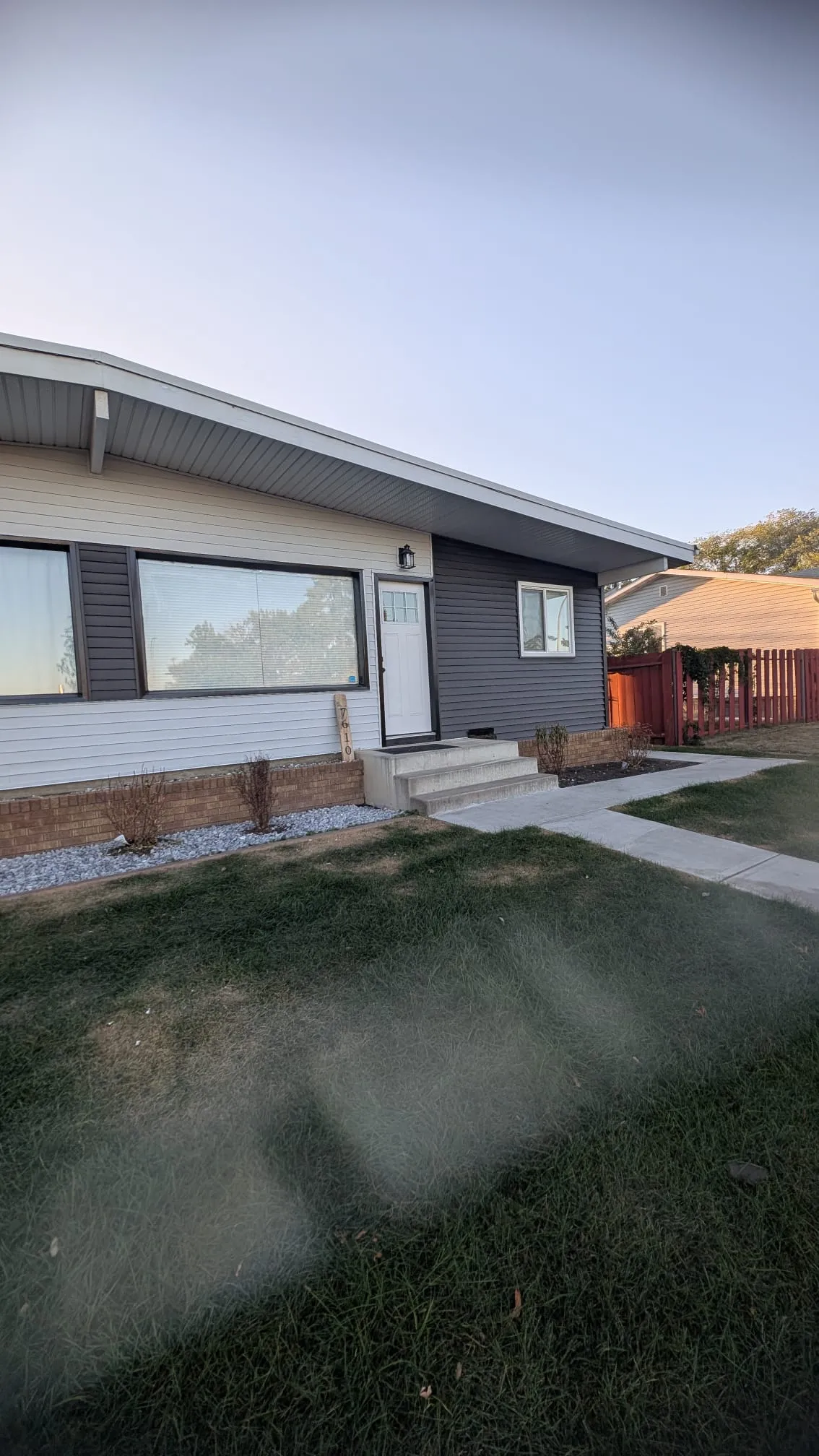 ACR Construction completed bungalow renovation with new grey and white siding